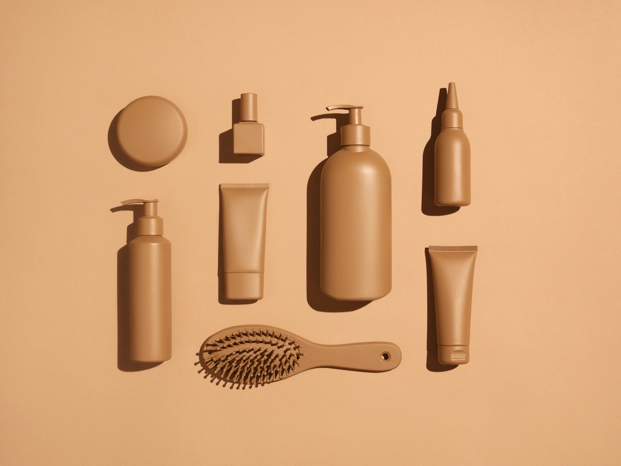 Neutral-toned cosmetic products flat lay