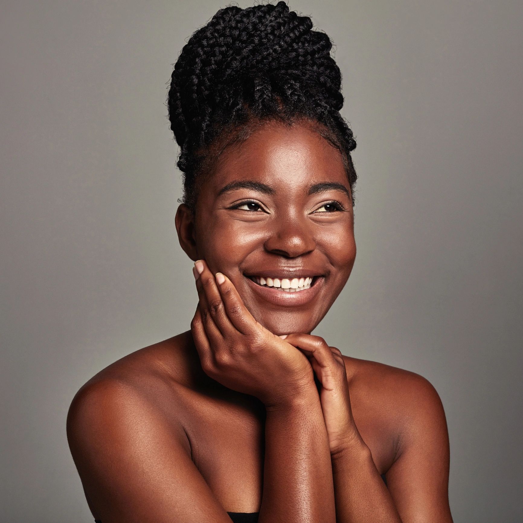 Portrait of a young woman against a grey background